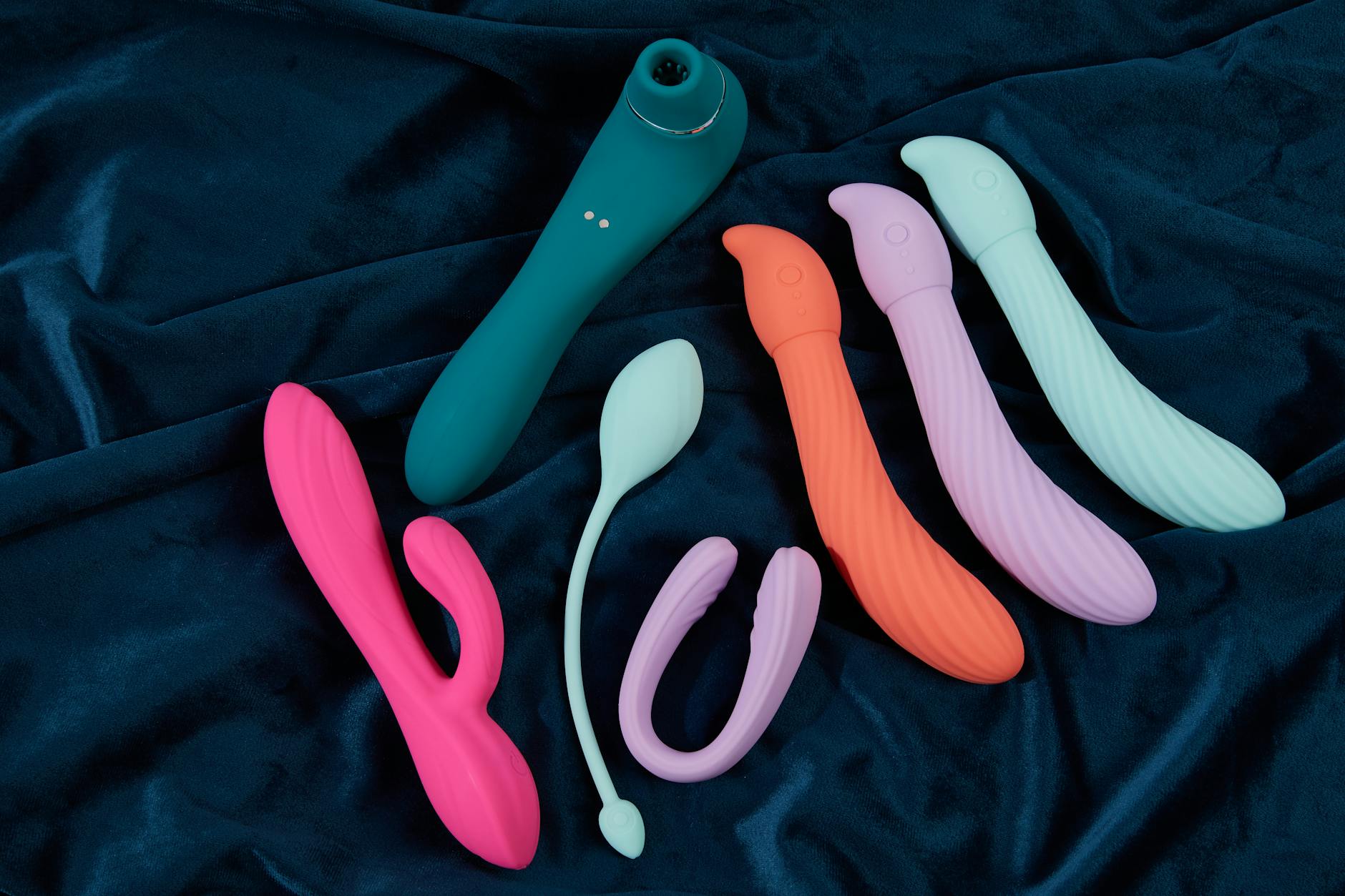 Person holding a clitoral vibrator, contemplating desire and intimacy in relationships